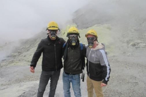 I can't figure out why no one can see them smiling, but Fernando Panduro (@PanduroFernando) and friends have safety masks on while exploring the sulphurous White Island in New Zealand: pic.twitter.com/ogFT71f4TW